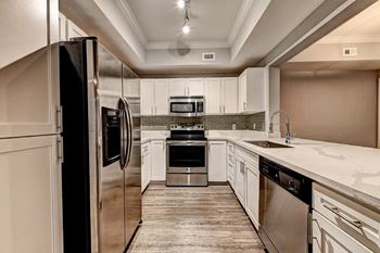 a kitchen with stainless steel appliances and white cabinets